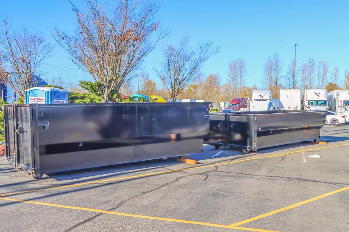 Professional dumpster rental service with roll-off container on residential driveway in Punxsutawney